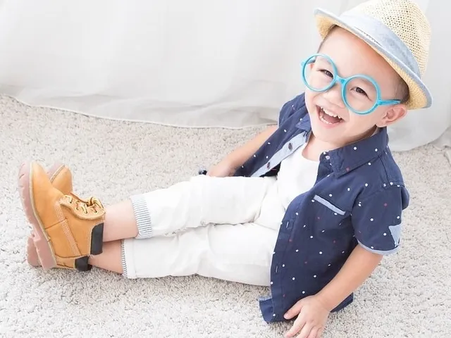 happy little boy wearing blue rimmed eyeglasses 640