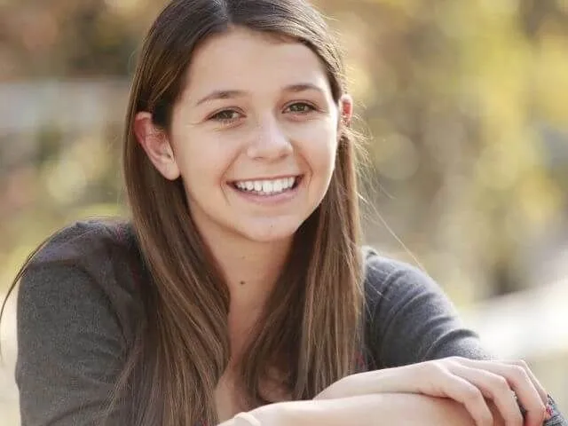 teen girl smiling brunette contacts ortho k 640px