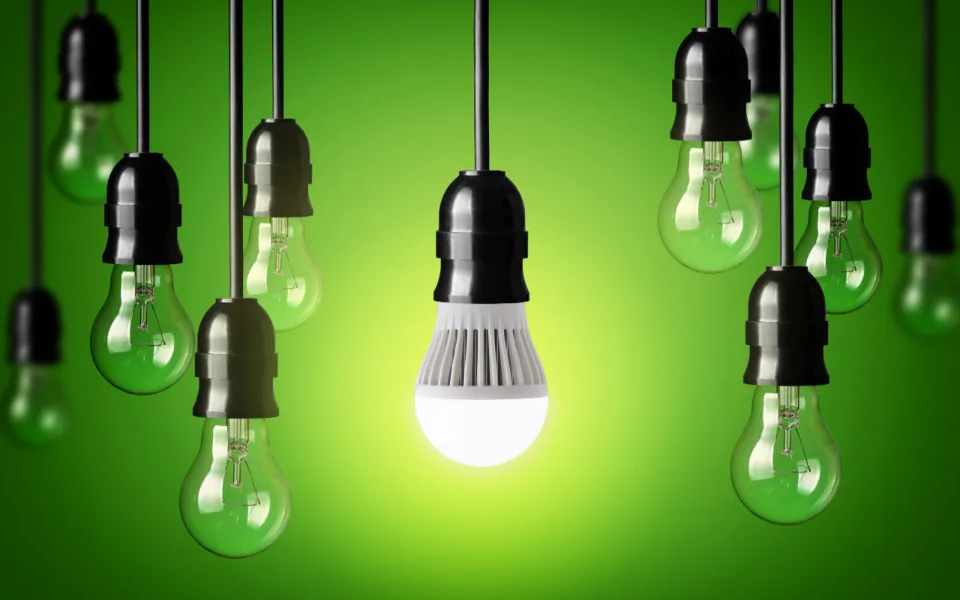 eleven lightbulbs, the only one that's on is the one in the middle, it also has a dark green to light green background - LasVegasRealEstate.com