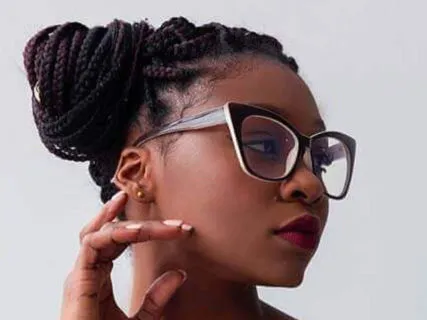 Stylish woman wearing oversized glasses and floral dress