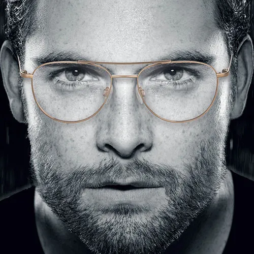 Man in grayscale portrait wearing Charmant Titanium glasses