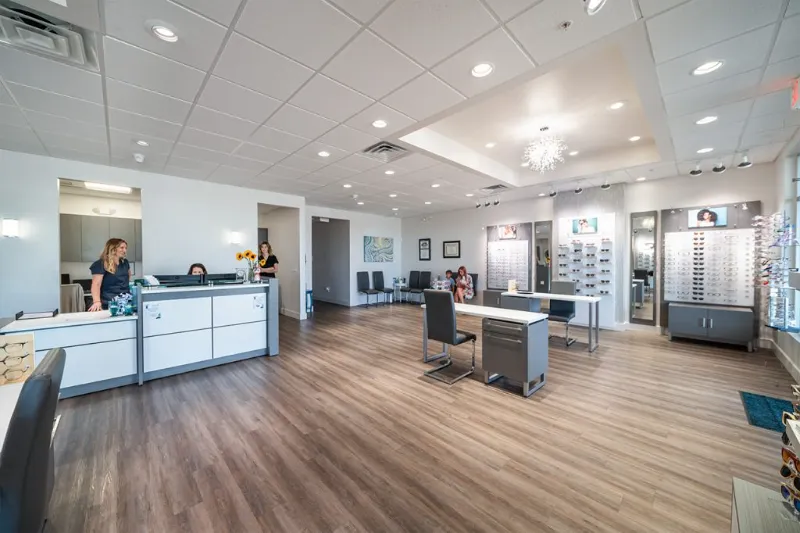 Modern optometry office with reception desk and eyewear displays